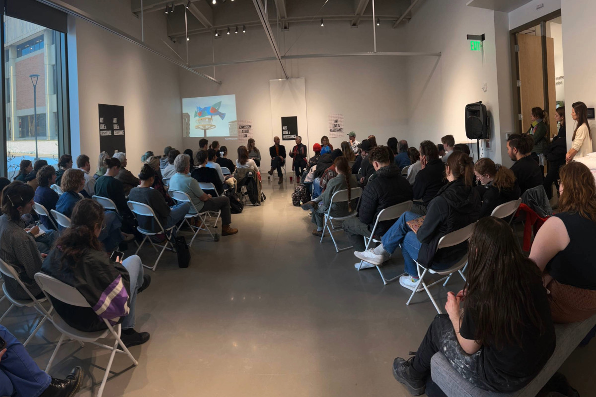 In the Gittins Gallery, students, faculty, and community members listen attentively, while the SmART Start panelists share their professional advice.